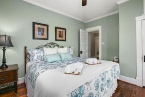 a bedroom with a large bed with towels on it at Blue Gumbo Gorgeous and Located a Few Minutes Walk to Beach in Galveston