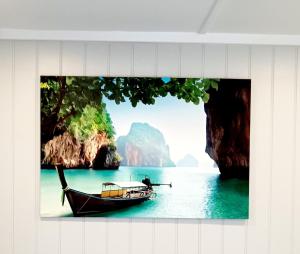 a picture of a boat in the water with cliffs at Garden Guesthouse, Sleep4, Private Entrance, Parking, Wifi, AirCon, Derby City in Derby