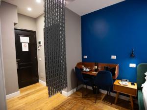 a room with a table and a blue wall at Jb Relais Luxury in Rome +45 photos