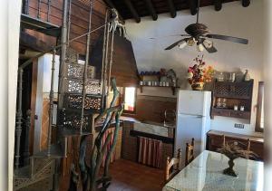 a kitchen with a white refrigerator and a ceiling fan at EL PUEBLO III -venga al pueblo- in Calañas