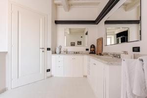 a white bathroom with a sink and a mirror at Cosimo Charme in Chianti in Barberino di Val dʼElsa +54 photos