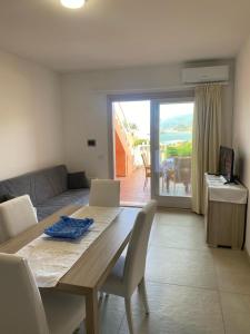 a living room with a wooden table and a couch at Sea View - Bosa, Sardegna in Magomadas