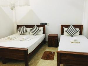 Letto o letti in una camera di Dimuthu Green Villa