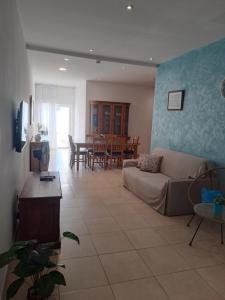 a living room with a couch and a table at Il-Qastna Holiday House in Żejtun
