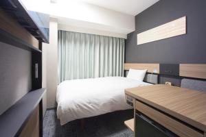 Postel nebo postele na pokoji v ubytování Washington R&B Hotel Shin Yokohama Ekimae