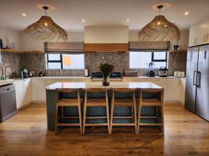 a kitchen with a large island in the middle at Ochre and Ash in Clanwilliam