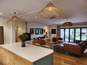 a living room with two chandeliers and a living room at Ochre and Ash in Clanwilliam