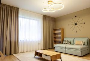 a living room with a couch and a table at Alpine Nest Grand Chalet in Poiana Brasov