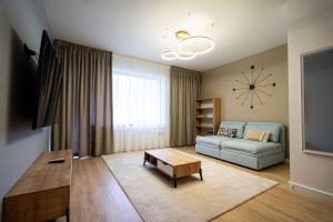 a living room with a couch and a table at Alpine Nest Grand Chalet in Poiana Brasov