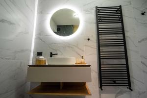 a bathroom with a sink and a mirror at Alpine Nest Grand Chalet in Poiana Brasov +22 photos