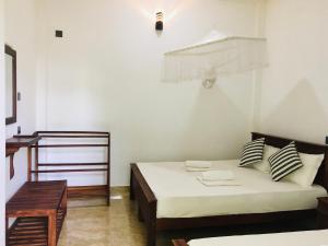 Letto o letti in una camera di Dimuthu Green Villa