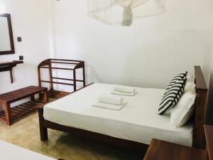Letto o letti in una camera di Dimuthu Green Villa