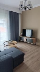 a living room with a couch and a tv at La Bella casa kavala in Kavala