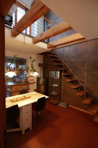 a kitchen with a staircase and a table with chairs at Maison Marie in Ubstadt-Weiher +25 photos