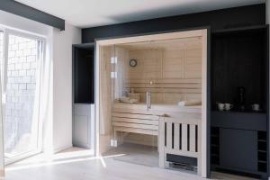 a bathroom with a shower with a wooden door at Boutiquehotel Reuter GmbH in Hattingen
