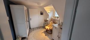 an attic room with a bed and a desk and a room with a room at Büsumhaus Birgit in Büsum