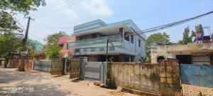 a house on the side of a street with a fence at Sukumar Villas in Nellore