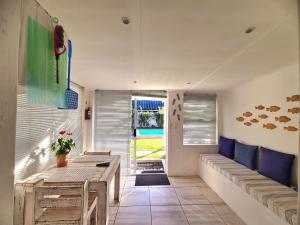 a room with benches and a table and a window at 57 on Vermont in Hermanus