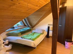 a attic room with a bed in the attic at Poddasze Pierwoszyno in Pierwoszyno