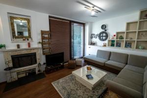 a living room with a couch and a fireplace at Apartament Vila 12 in Durrës