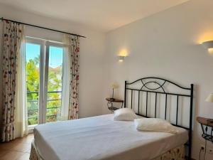 a bedroom with a bed and a large window at Grupo Morgado - Quinta do Morgado - Morgado Pool View in Tavira +65 photos