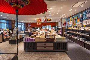 a store with a large red umbrella in a store at KAMENOI HOTEL Kusatsu Yubatake in Kusatsu