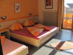 un letto in una camera con due cuscini sopra di Pension Lärchenhof a Döbriach