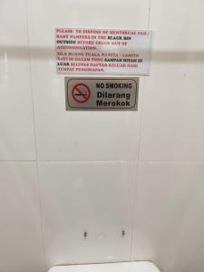 a no smoking sign in a bathroom with a toilet at Desa Besut Inn in Kuala Besut +14 photos