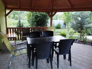 a wooden table and chairs on a patio at Apartmán Greenhouse in Budikovany