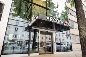 a facade of a car dealership with a sign on it at ARCOTEL AQ Wien in Vienna
