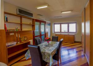 a dining room with a table and chairs at Sunset Suites Füred in Balatonfüred