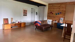 a living room with a chair and a table at Casa Sanuk in Poio