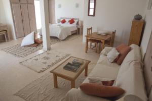 a living room with a couch and a table at Villaseahouse in Sidi Ifni
