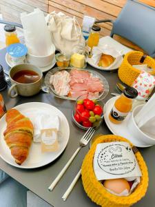 a table with plates of food and eggs on it at Apartment House Artes with Free Hot Tub & Sauna in Branik