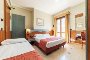 Postel nebo postele na pokoji v ubytování Hotel Riviera Fiumicino