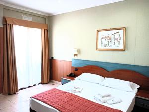 Postel nebo postele na pokoji v ubytování Hotel Riviera Fiumicino