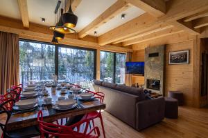 a dining room with a long table and chairs at Enklawa Natura in Kościelisko