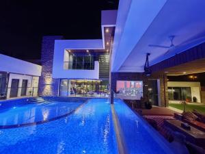 a large swimming pool in a building at night at G R A N D C H A L E T in Salalah