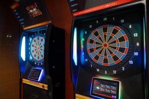 two video game machines sitting next to each other at KAMENOI HOTEL Kusatsu Yubatake in Kusatsu