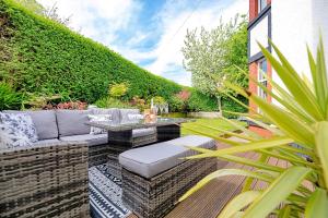 a patio with a couch and a table at Finest Retreats - Sea Bank in Colwyn Bay