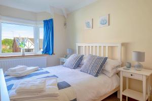 a bedroom with a large bed with a window at Finest Retreats - Sea Bank in Colwyn Bay