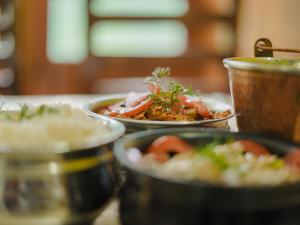 a table with three plates of food on it at Venky's Place in Jibhi