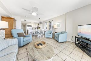 a living room with a couch and a table at Four Winds 301 in Orange Beach