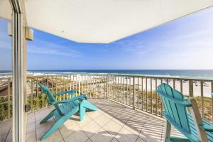 two blue chairs on a balcony overlooking the beach at Four Winds 301 in Orange Beach +37 photos