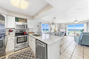 a kitchen with a view of the ocean at Four Winds 301 in Orange Beach