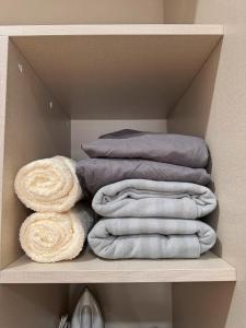 a pile of towels sitting on a shelf at Country Garden Danga Bay By Minshuku in Johor Bahru