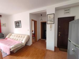 a living room with a white couch in a room at MiNa Apartments in Petrovac na Moru