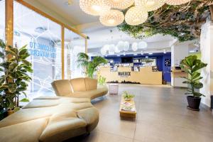 a store with a couch in a room with potted plants at Maverick Budapest Soho in Budapest