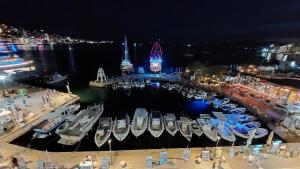 a group of boats docked at a marina at night at Sun N Blue Hotel in Sarandë