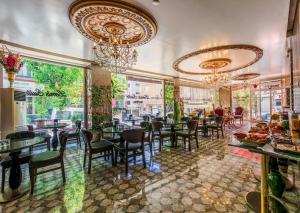 a restaurant with tables and chairs and chandeliers at Lemis Suite Istanbul in Istanbul